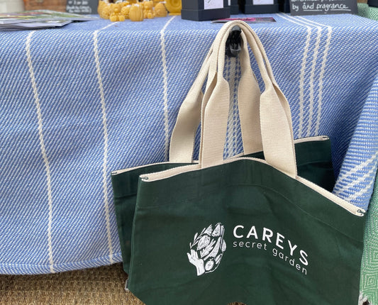 Carey’s canvas tote bag, featuring a simple, stylish design with the Carey’s logo, perfect for carrying essentials while supporting sustainable, eco-conscious brands