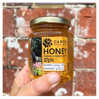 Carey’s honey jar, filled with locally sourced, golden honey harvested from the garden’s hives, offering a natural and delicious product in a simple glass jar