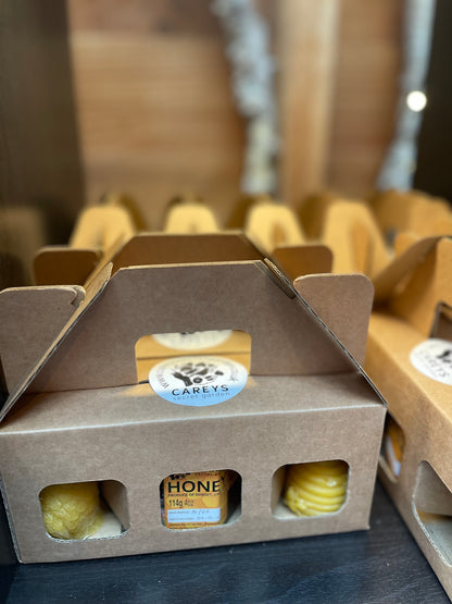 Carey’s honey gift sets, featuring a 4oz jar of our honey and two beeswax candles, beautifully packaged for a thoughtful and sustainably sourced gift.