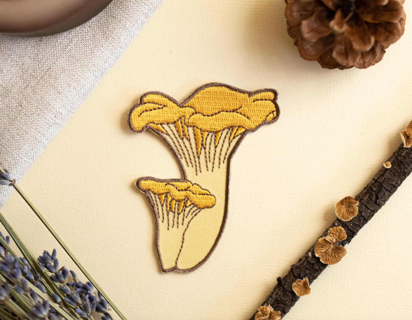 Embroidered fungi patch by Moss and Morcella, featuring a detailed illustration of mushrooms, capturing the natural beauty and intricate design of various fungi species.