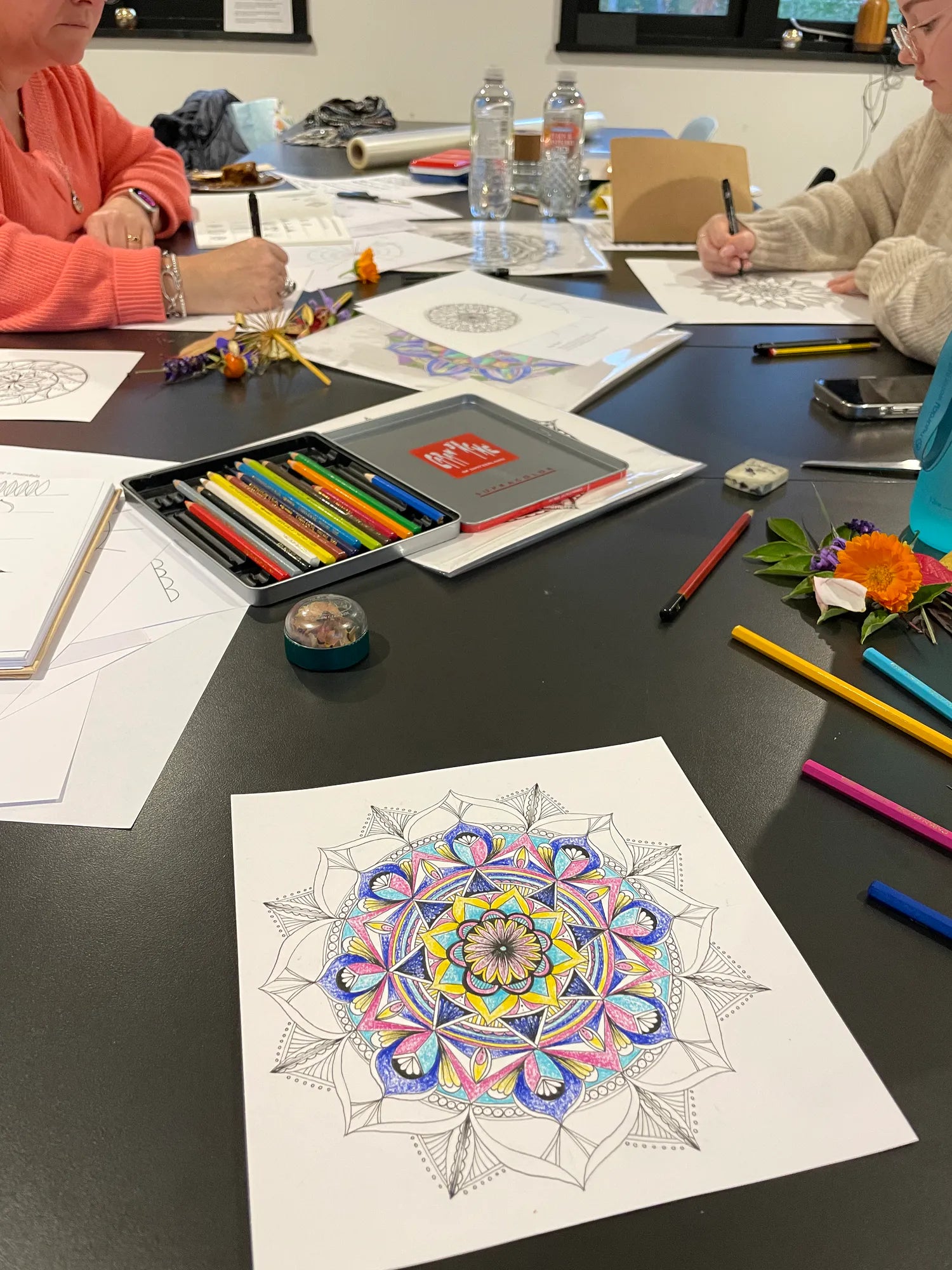 Hand-drawn mandalas created during a mindful workshop at Carey’s, showcasing intricate designs that promote relaxation, creativity, and focus in a peaceful, nature-inspired setting