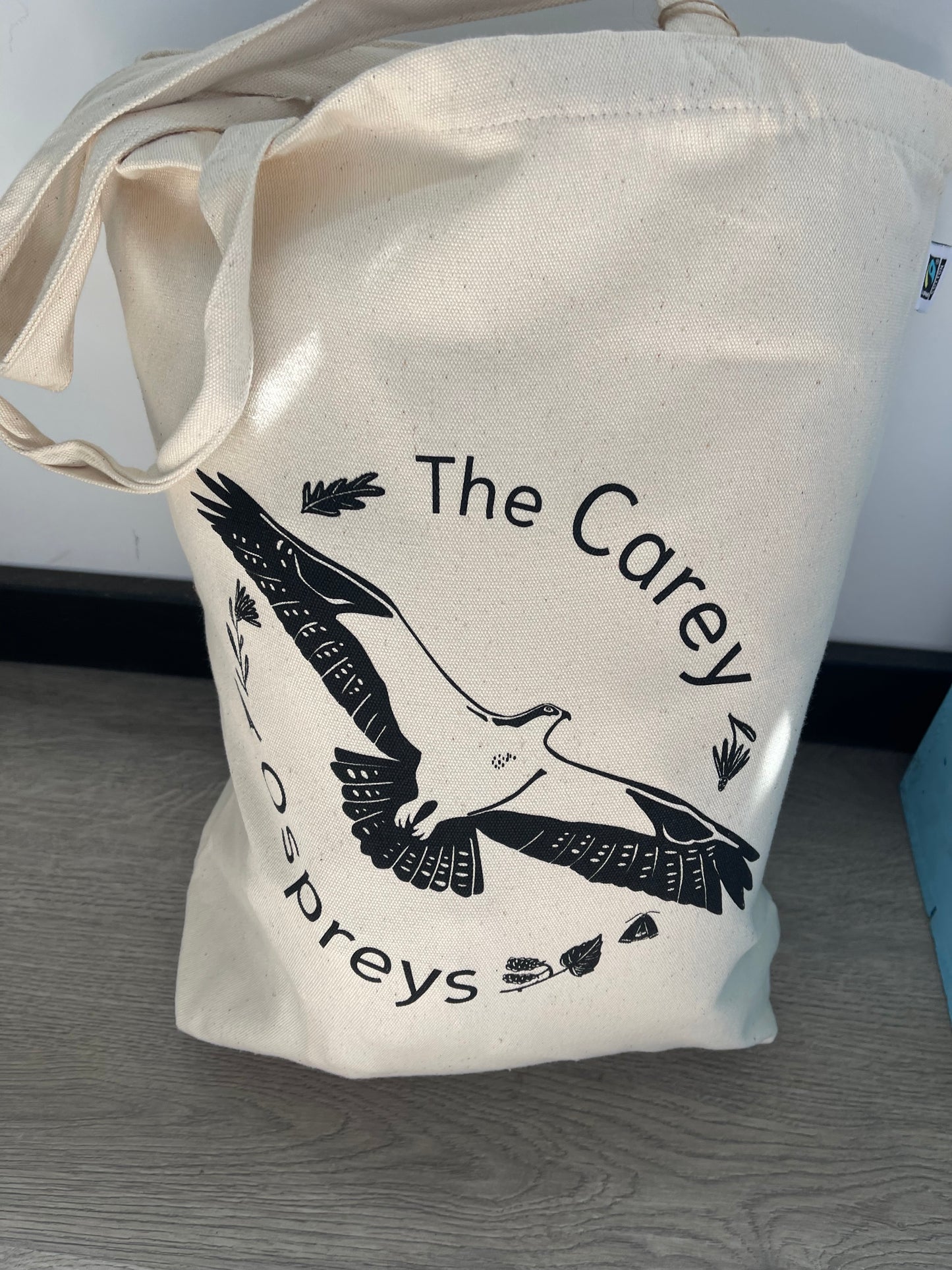 Carey Ospreys cotton tote bag featuring a stylish hand-drawn design of an osprey in flight, perfect for carrying essentials while supporting nature conservation