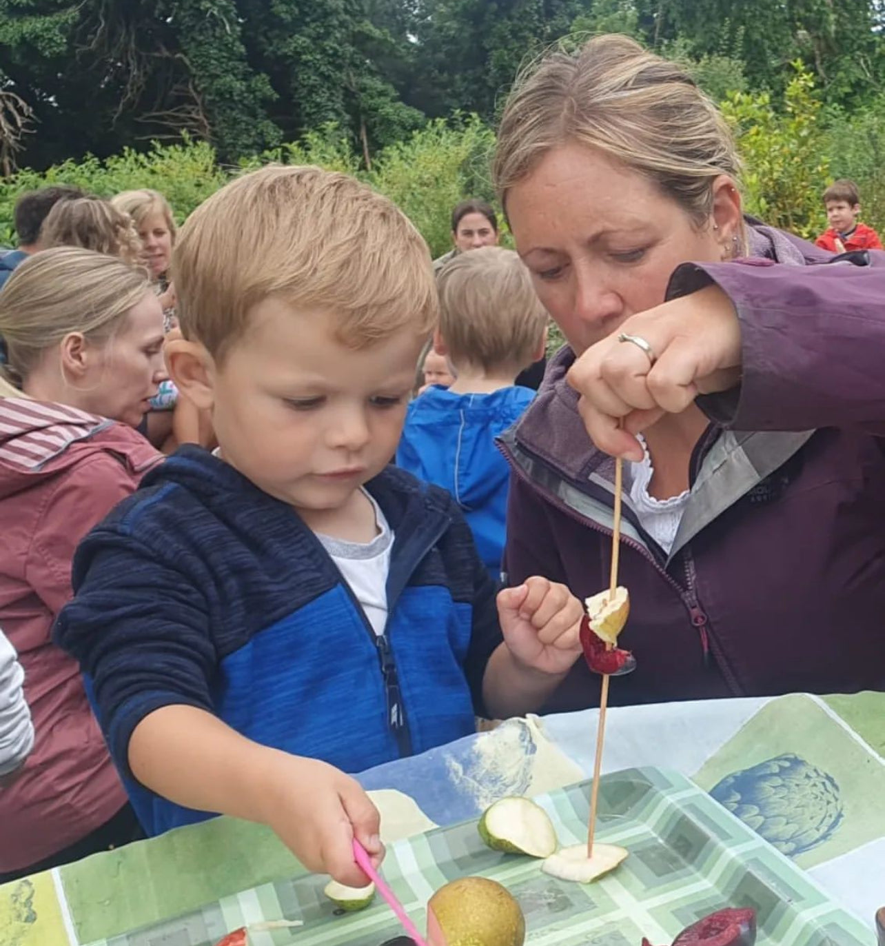 Toddler and mum crafting insect and bird feeders at Carey’s during a weekly parent and toddler group, enjoying a hands-on, nature-inspired activity in a peaceful outdoor setting.