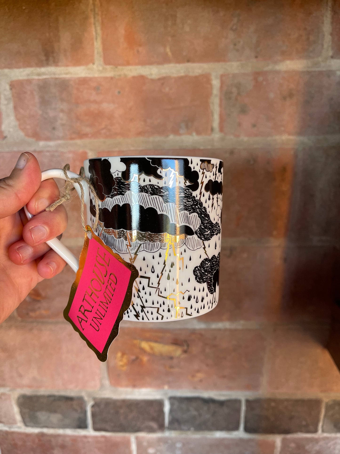 Arthouse Unlimited Rumble China mug featuring a beautiful monochrome and metallic cloud design, created by artists with learning disabilities to support their creative work