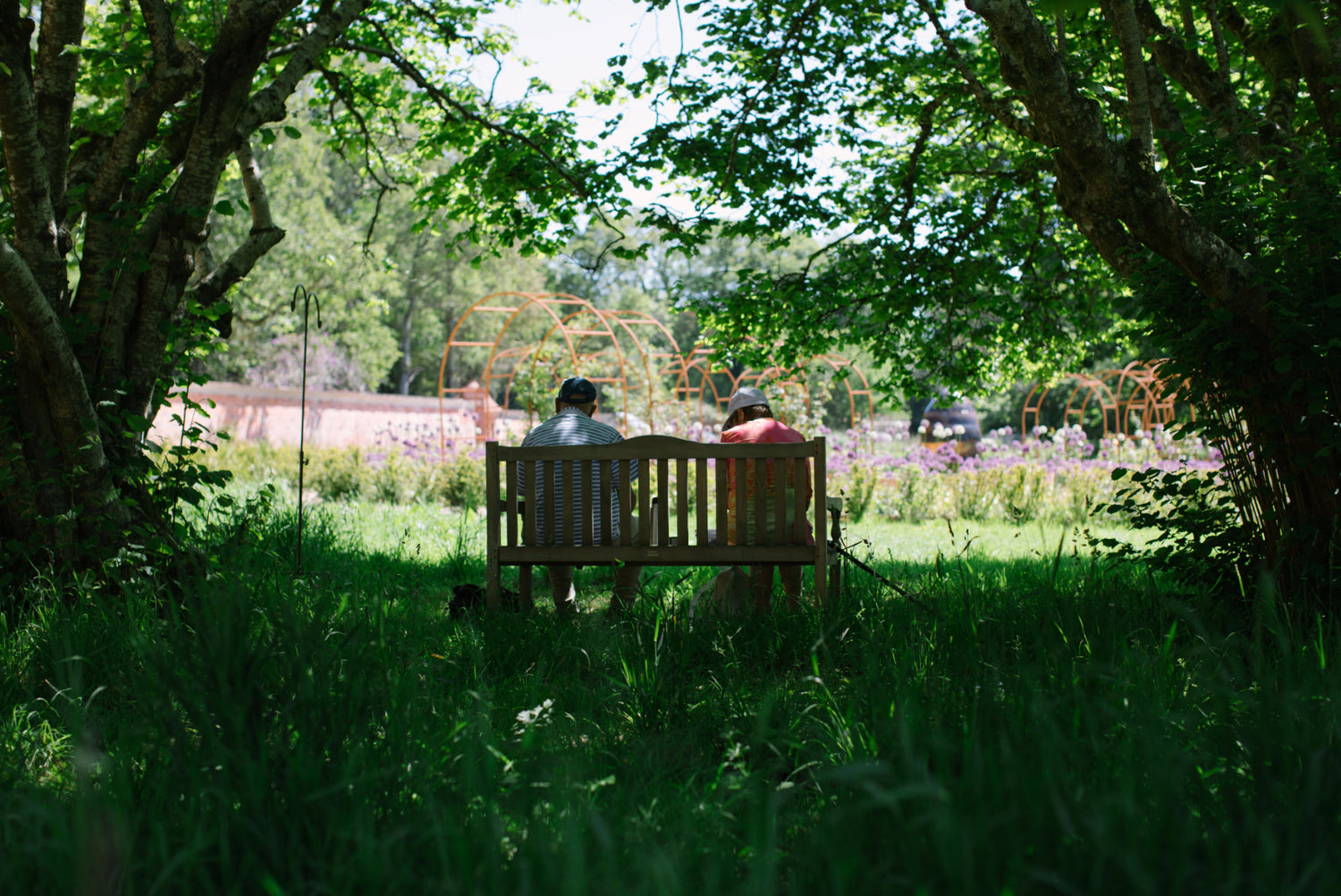 Visitors enjoy a shaded seating spot in Careys Secret Garden