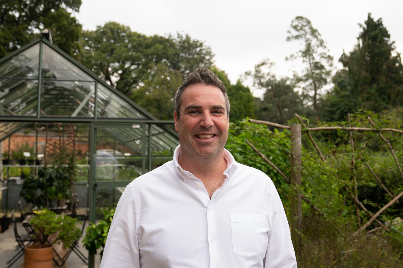 Simon Constantine, founder of Carey’s Secret Garden, standing amidst the lush greenery of the garden, reflecting the passion and vision behind this nature-filled sanctuary