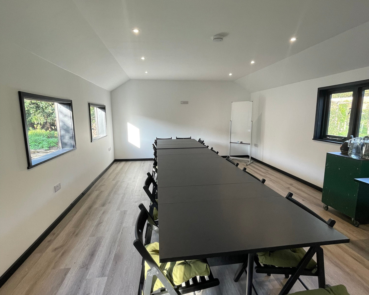 The Workroom at Careys featuring desks, a whiteboard, and a bright, functional space designed for meetings, workshops, and creative sessions in a peaceful setting